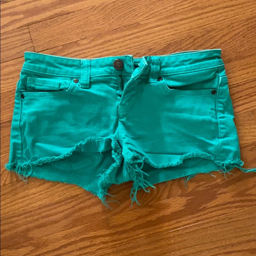 Green ripped denim shorts